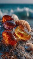 Beautiful amber and golden stones scattered on wet beach sand near ocean waves at sunrise photo