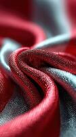 Red and silver fabric drapes create an elegant texture in soft lighting at an artistic display photo