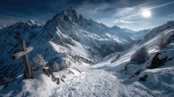 Expansive winter landscape with snow-covered mountains and a wooden cross marking the path in high alpine terrain photo
