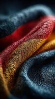 Vibrant folds of fabric display the colors of the German flag in intricate detail in a striking close-up shot photo