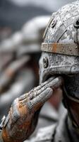 Soldiers in dusty uniforms silently salute during an outdoor military ceremony in a mountainous region at dusk photo