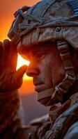 Soldier saluting during sunset, showcasing determination and respect for duty in a warm glow of evening light photo