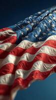 American flag waving against a blue background, showcasing vibrant colors and rich details, symbolizing patriotism and unity photo