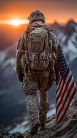 Soldier walking on mountain ridge at sunset carrying American flag in rugged terrain photo