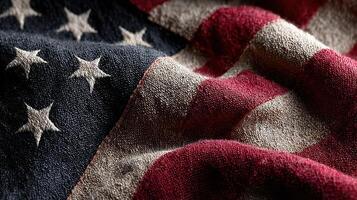 American flag fabric draped in folds with a weathered and textured appearance showcasing deep colors and stars photo