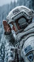 Soldier saluting in a snowy forest during winter operations at dusk photo