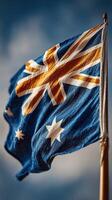 Waving Australian flag against a clear blue sky highlighting national pride and identity photo