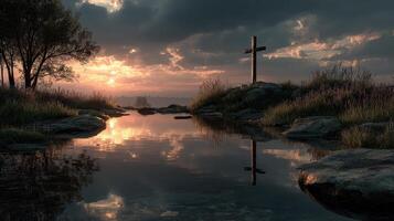 Sunset reflection over calm water near a cross on a hill surrounded by trees and grasses photo