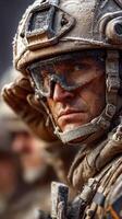 Soldier in combat gear stands vigilant amidst a snowy landscape during a military operation at dawn photo