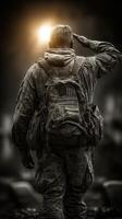 Soldier saluting at sunrise in a solemn tribute to fallen comrades during a memorial ceremony photo