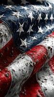 Worn and weathered American flag with intricate details of fabric and color against a dark background photo