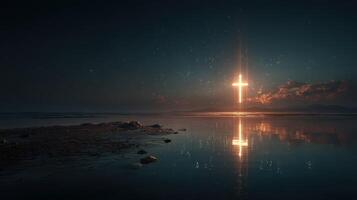 Illuminated cross shining over calm water during twilight at a serene coastal location photo