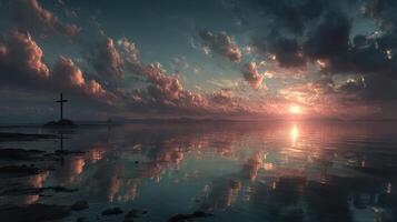 Sunset over calm waters with clouds reflecting near a cross on a rocky island photo