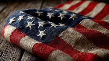 Worn American flag draped on rustic wooden surface showcasing colors of freedom and patriotism photo