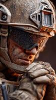 Military soldier in tactical gear preparing for a mission in a rugged environment during early morning light photo