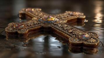 Ornate cross reflecting in shallow water at a dimly lit setting during peaceful moment of contemplation photo
