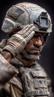 Soldier saluting in a dusty environment during a mission in a conflict zone at dusk photo
