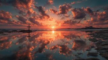 Sunset over calm waters with cross silhouette and colorful clouds at the beach during twilight hours photo