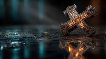 Ornate cross resting on a reflective surface in a dimly lit environment with a mystical ambiance photo