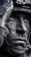 Soldier saluting with determination while covered in dirt during military training exercise in a forested area photo