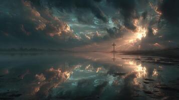 Golden rays break through dark clouds over serene waters reflecting a cross at sunset near a tranquil landscape photo
