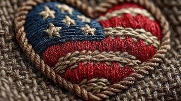 Embroidered heart with American flag design on textured fabric in warm lighting photo