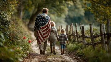 Walking along a rustic path, a parent and children enjoy the beauty of nature wrapped in an American flag blanket during a peaceful afternoon photo