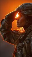 Soldier saluting during sunset in a mountainous landscape with sunlight illuminating her silhouette photo