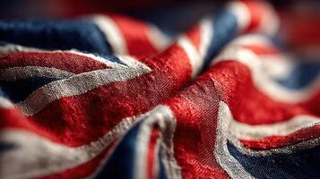 Close-up view of a textured UK flag showing vibrant colors and intricate fabric details in soft lighting photo