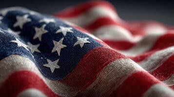 American flag draping gracefully in soft light showcases patriotism and texture in a close-up view photo