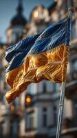 Vibrant Ukrainian flag waving in the wind against a historic city backdrop during a sunny afternoon photo