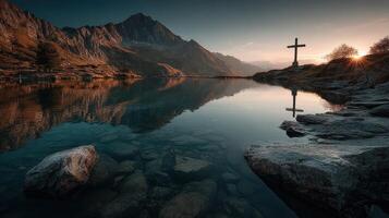Serene mountain landscape at sunset with cross reflection in tranquil lake water photo
