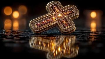 Decorative golden cross reflecting soft candlelight on a dark surface during a serene evening photo