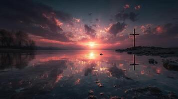 Sunset reflection on water with a cross silhouette at the shore during dusk photo