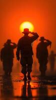 Soldiers saluting against a stunning sunset in a foggy landscape photo