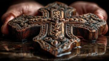 Hands holding a beautifully carved wooden cross in soft light, evoking serenity and spirituality during quiet contemplation photo