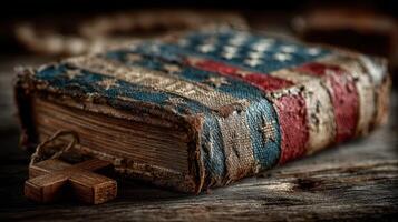 Vintage book with American flag design resting on rustic wooden surface in dim light photo
