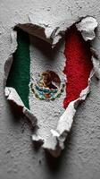 Cracked wall revealing vibrant Mexican flag in heart shape against textured background photo