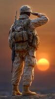 Soldier saluting at sunset while stationed in a desert environment, symbolizing duty and honor photo