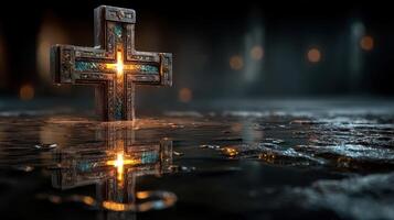 Ancient cross reflecting in water with glowing details in a dimly lit environment photo