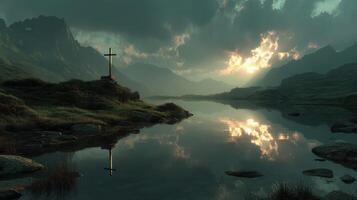 Sunset reflections over a tranquil lake with a cross on a hill surrounded by mountains photo