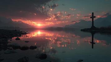 Serene sunset over a tranquil lake with a cross silhouette and mountains in the background photo