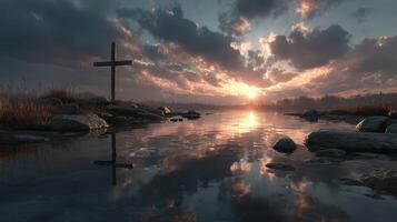 Sunset over a tranquil river with a cross and rocky shoreline reflecting in the water photo