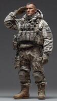 Soldier in combat uniform saluting while wearing tactical gear in a neutral background setting photo