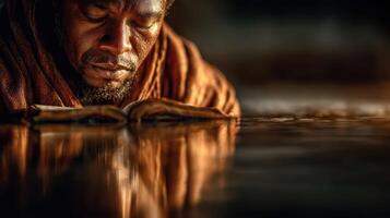 Ancient scholar immersed in reflection while studying an old book near calm waters at sunset photo