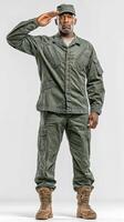 Man in military uniform salutes while standing in a neutral background during daylight hours photo