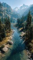 Scenic river flows through mountain valley surrounded by tall trees on a clear day photo