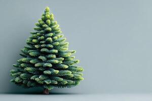 Lush artificial pine tree set against a muted blue background, perfect for holiday decorations and celebrations photo
