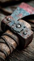 Rusty axe resting on a weathered wooden surface surrounded by natural light in a rustic setting photo