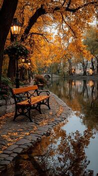Autumn evening by a tranquil river with a bench surrounded by golden leaves and warm lantern light photo